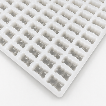 Close-up of a 2.3mL gummy bear silicone mold with 230 cavities on a clean white background