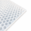 Close-up of a 3mL hexagon gem gummy mold with 263 cavities on a white background