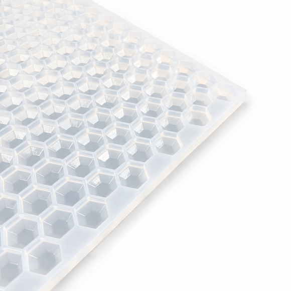 Close-up of a 3mL hexagon gem gummy mold with 263 cavities on a white background